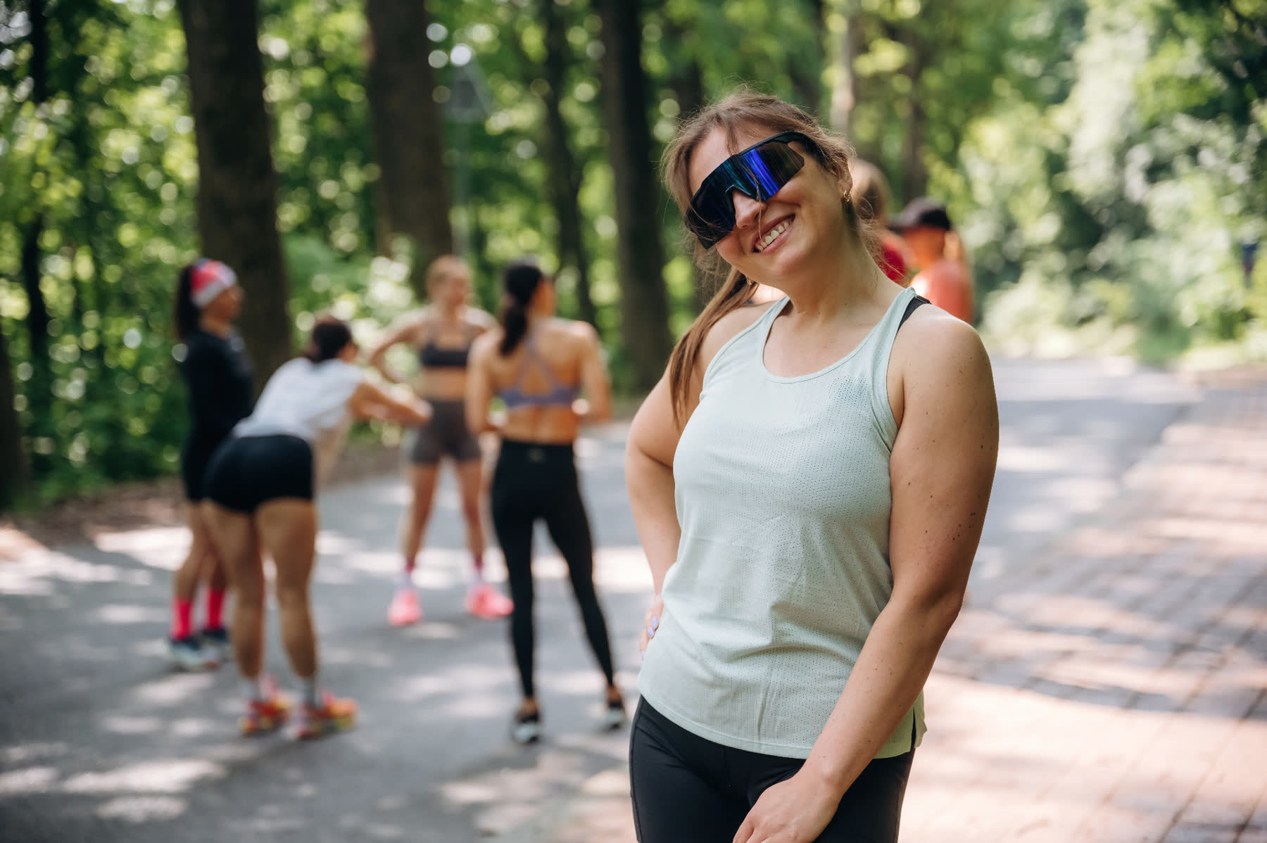 Player smiling in sports tank and mirrored shield sunglasses